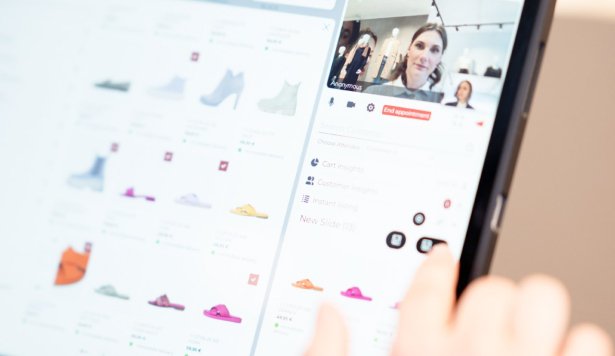 A person browses shoes on a tablet, with product images on the left and a video call on the right. The person’s finger points at an option on the screen.